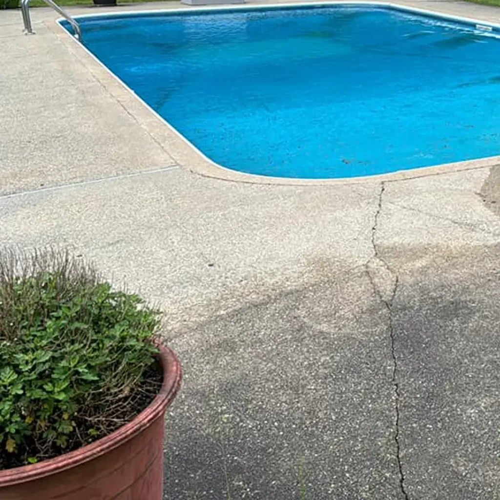 concrete pool deck pressure washed with pool in background in Leeming
